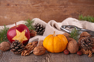 a pumpkin with fruit on top of a wooden table